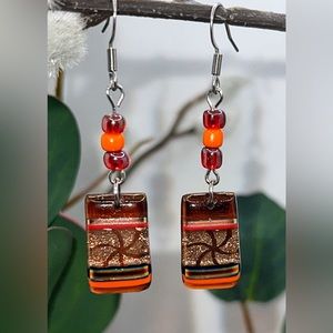 Handmade glass dangle earrings with red opalescent/orange glass accent beads